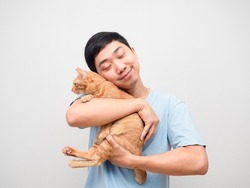 Asian man hug his cat orange color in hand feeling happy