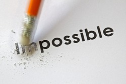 Changing the word impossible to possible with a pencil eraser