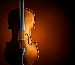 Violin resting against a blank grunge background with copy space