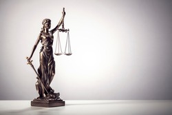 Legal law concept statue of Lady Justice with scales of justice background