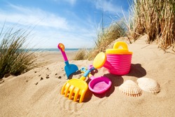 Summer beach toys in the sand concept for holiday and vacations