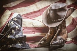 Antique vintage american flag, cowboy hat and boots, independence or memorial day concept