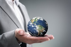 Businessman holding the world in the palm of hands concept for global business, communications, politics or environmental conservation

Earth image courtesy of Nasa

