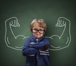 Strong man child showing bicep muscles concept for strength, confidence or defense from bullying