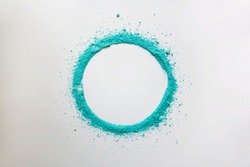 Turquoise colored powder circle frame on white background