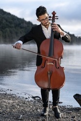cello player performing outdoors at sunrise