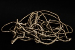 A heap of rope isolated on a black background. Shallow depth of field.