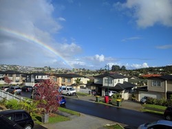 Auckland suburb, New Zealand - May 4 2020: the view of rainbow over residential buildings at North Shore on May 4 2020 in Auckland, New Zealand.