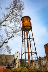 Old, rusted water tank tower for providing pressure to bourbon distillery close to Frankfort, Kentucky
