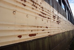 Close up to a rusty metal train wagon texture in sunny day