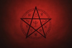 Pentagram symbol painted on paper with black paint. Occult and esoteric symbols. Spell or black magic ritual. Red color.