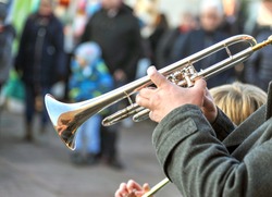 Brass band music outdoors - close up musician with trombone on an public event, selective focus