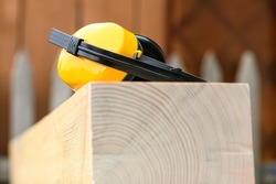Protective earmuffs when working with wood in a sawmill , close up