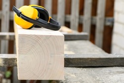 Protective earmuffs when working with wood in a sawmill , close up