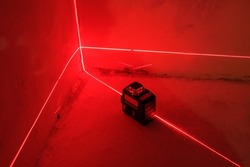Red Laser level turned on in a dark room