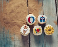 Few Summer Cupcakes On Wooden Planks And Sand