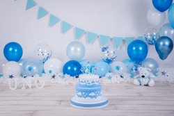 Lovely blue and white birthday cake whit colored balloons and stars.Birthday ideas for kids. Boy birthday celebration. Baby's first year. First year photoshoot.