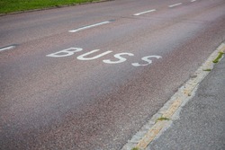 Close up view of bus Line road markings on asphalt road. Sweden. 