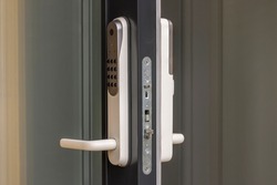 Close up view at open entrance door with modern white digital lock isolated. 