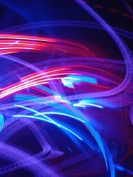 Blue and red light painting photography, long exposure fairy blue and red lights curves and waves against a black background. Long exposure light painting photography. Abstract pink purple swirls