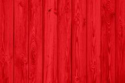 Red wood plank texture of pine grain with knots. Cool wooden background.