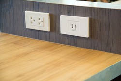 3 plugs and a USB plug on the gray table.