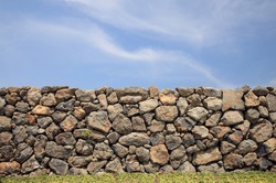 Jeju Island traditional thatched house stone wall - Korea
