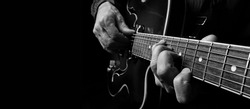 	
Guitarist hands and guitar close up. playing electric guitar. copy spaces. black and white.	
