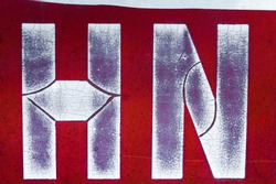 Old cracked and peeling paint, letter H, letter N on metal.