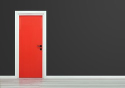 Red door with black handle in a dark grey wall