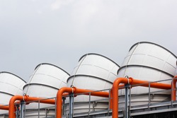 Exhaust air vent from the cooling tower with the orange water pipelines