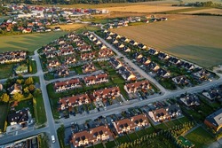 Aerial view of suburban neighborhood, Residential district with buildings and streets at small european town at sunset