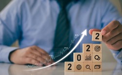 2022 Successful Business Development and Growing Growth Ideas business analysis and financial concepts with statistical graph Place wooden blocks, icons and numbers 2022.