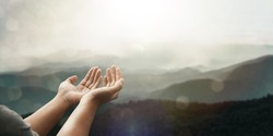 The two hands of a young man who prayed for hope from God Praise God concept. Pray, communicate. Mountain nature background. at sunrise