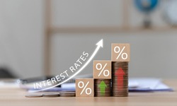 Interest on stacks of US dollars on a wooden table with an arrow pointing up. Finance and Mortgage Interest Rate Ideas wooden block with percentage icon and arrow pointing up the economy is improving