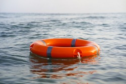 Red lifebuoy in sea on water. 