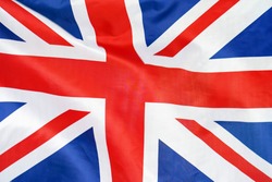 Fabric texture flag of United Kingdom. Flag of United Kingdomwaving in the wind. UK flag is depicted on a sports cloth fabric with many folds. Sport team banner.