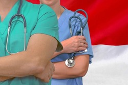 Close-up medical team man and woman surgeons of the Indonesia flag background. Professional surgery in Indonesia. Medical technology research institute and doctor staff service concept in Indonesia