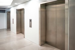 Three elevator doors in office building. Wide angle view of modern elevators with doors. Elevators in the modern lobby house or hotel
