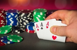 Poker cards with three of a kind or set combination. Close up of gambler hand takes playing cards in poker club