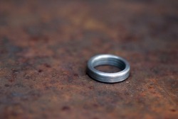 Single steel ring on a rusty surface