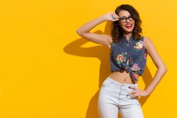 Shouting Girl In Glasses Posing In The Sunlight On Yellow Background