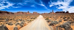 Panorama of the road through the canyon desert. Red rock canyon desert road. Canyon desert road panoramic landscape. Canyon road panorama