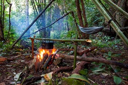 Jungle barbecue with open fire in the middle of a asian bamboo forrest