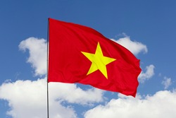 Vietnam flag isolated on the blue sky with clipping path. close up waving flag of Vietnam. flag symbols of Vietnam.