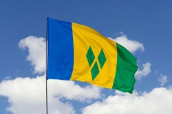 Saint Vincent and the Grenadines flag isolated on sky background with clipping path. close up waving flag of Saint Vincent and the Grenadines. flag symbols of Saint Vincent and the Grenadines.