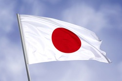 Japan flag isolated on sky background. close up waving flag of Japan. flag symbols of Japan.