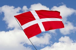 Denmark flag isolated on sky background with clipping path. close up waving flag of Denmark. flag symbols of Denmark.