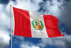 Peru flag on sky and cloud background. National symbols of Peru. Flag of Peru.