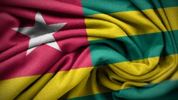 The national flag of Togo. Togo flag with fabric texture. Close up waving flag of Togo.